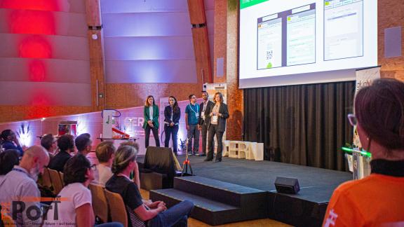 A team of innovators presenting their project inside Cern's Dome building